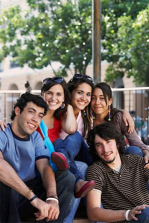 Portrait of three young women and two young men sitting together and smiling Stock Photo - Premium Royalty-Free, Code: 625-01746340