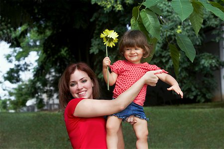 Portrait of a young woman picking up her daughter and smiling Stock Photo - Premium Royalty-Free, Code: 625-01746401
