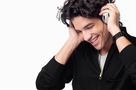 simsearch:625-01746391,k - Close-up of a young man listening to music and smiling Foto de stock - Sin royalties Premium, Código: 625-01746433