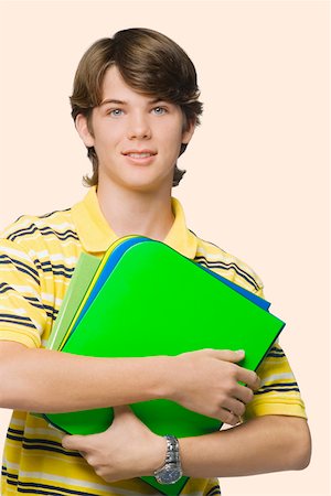 simsearch:625-01746920,k - Portrait of a teenage boy holding books and ring binders Foto de stock - Sin royalties Premium, Código: 625-01746527
