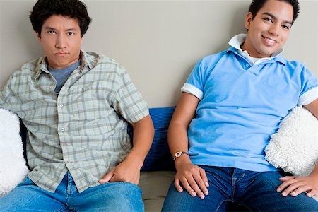 simsearch:625-01747650,k - Two young men sitting on a couch Stock Photo - Premium Royalty-Free, Code: 625-01746632