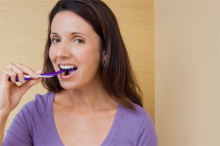 dental care woman - Portrait of a mid adult woman brushing her teeth Stock Photo - Premium Royalty-Free, Code: 625-01746643