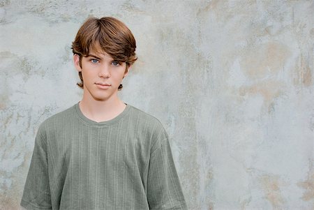 Portrait of a teenage boy standing in front of a wall Stock Photo - Premium Royalty-Free, Code: 625-01746689