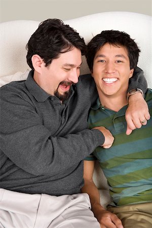 Mid adult man with his arm around his son Stock Photo - Premium Royalty-Free, Code: 625-01746720