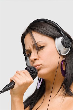 puckered lips profile - Portrait of a young woman singing into a microphone Stock Photo - Premium Royalty-Free, Code: 625-01746850