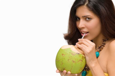 Portrait of a young woman drinking coconut milk Stock Photo - Premium Royalty-Free, Code: 625-01746853