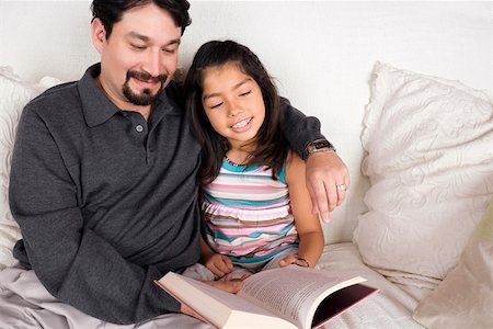 simsearch:400-08891803,k - Close-up of a mid adult man and his daughter reading a book Stock Photo - Premium Royalty-Free, Code: 625-01746929