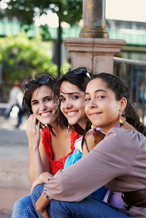 simsearch:625-01746725,k - Side profile of three young women sitting together and smiling, Old San Juan, San Juan, Puerto Rico Stock Photo - Premium Royalty-Free, Code: 625-01746963