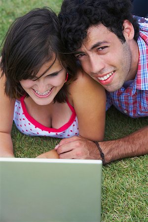 simsearch:625-01747054,k - Close-up of a young couple lying in a lawn in front of a laptop Foto de stock - Sin royalties Premium, Código: 625-01747044