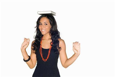 excited college student with books - Portrait of a teenage girl with a book on her head Stock Photo - Premium Royalty-Free, Code: 625-01747178