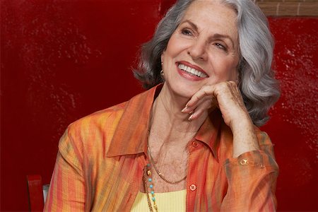 Close-up of a senior woman smiling with her hand on her chin Stock Photo - Premium Royalty-Free, Code: 625-01747224