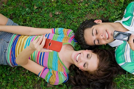 High angle view of a young couple lying in a park Stock Photo - Premium Royalty-Free, Code: 625-01747296