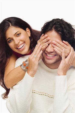 simsearch:625-01747054,k - Portrait of a young woman covering eyes of a young man from behind and smiling Foto de stock - Sin royalties Premium, Código: 625-01747306