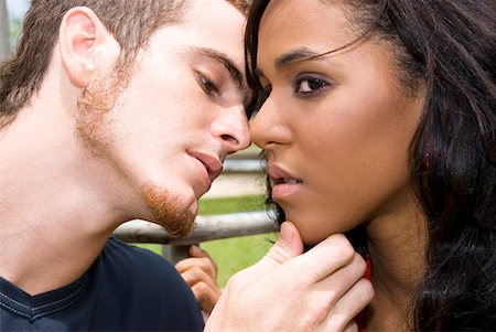Close-up of a young man kissing a teenage girl Stock Photo - Premium Royalty-Free, Code: 625-01747371