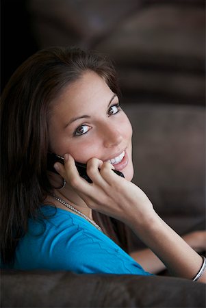 Portrait of a young woman talking on a mobile phone Stock Photo - Premium Royalty-Free, Code: 625-01747450