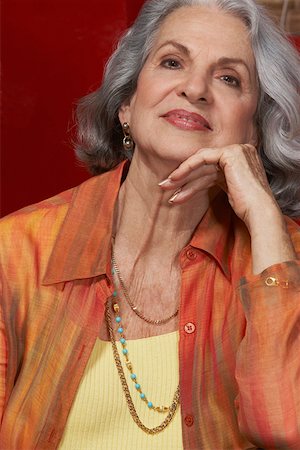 Close-up of a senior woman smiling with her hand on her chin Stock Photo - Premium Royalty-Free, Code: 625-01747453