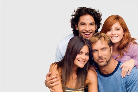 Close-up of a young man smiling with his friends Stock Photo - Premium Royalty-Free, Code: 625-01747466