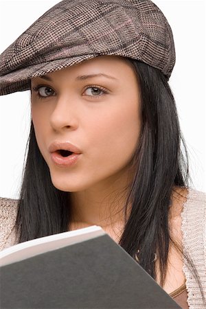 simsearch:625-00850090,k - Portrait d'une jeune femme siffler avec un livre devant elle Photographie de stock - Premium Libres de Droits, Code: 625-01747496
