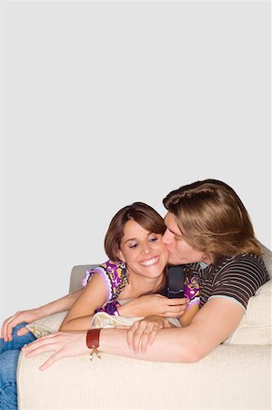 simsearch:625-01746920,k - Young man kissing a young woman on a couch Foto de stock - Sin royalties Premium, Código: 625-01747522