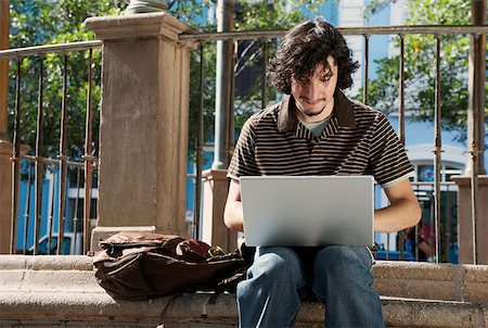 Young man using a laptop Stock Photo - Premium Royalty-Free, Code: 625-01747556