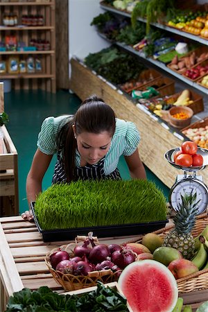 Young woman standing in a grocery store and looking at wheatgrass Foto de stock - Sin royalties Premium, Código: 625-01747606