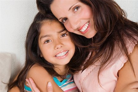 Portrait of a mid adult woman hugging her daughter Stock Photo - Premium Royalty-Free, Code: 625-01747762