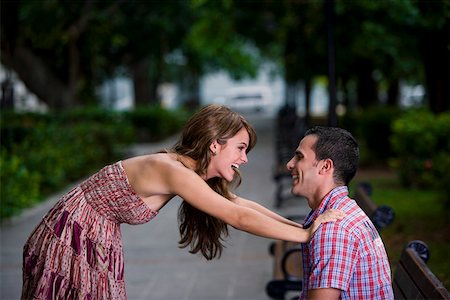 simsearch:625-01746515,k - Side profile of a young couple looking at each other and smiling Fotografie stock - Premium Royalty-Free, Codice: 625-01747884