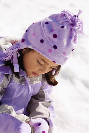 Close-up of a girl sitting on snow Stock Photo - Premium Royalty-Free, Code: 625-01747949