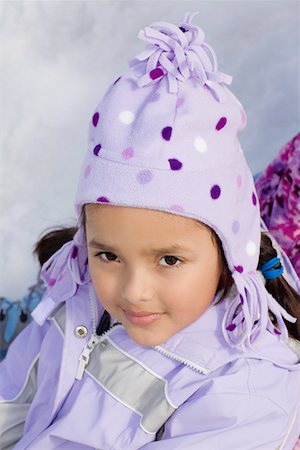 Portrait of a girl sitting in snow Stock Photo - Premium Royalty-Free, Code: 625-01747954