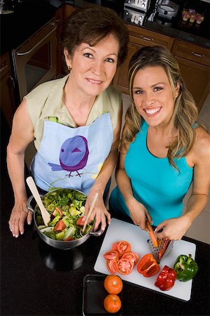 High angle view of a young woman preparing food with her mother in the kitchen Stock Photo - Premium Royalty-Free, Code: 625-01748222