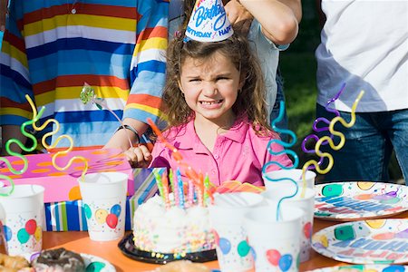 simsearch:625-01749029,k - Portrait of a girl standing in front of a birthday cake Stock Photo - Premium Royalty-Free, Code: 625-01748236