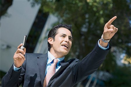 simsearch:625-02266709,k - Close-up of a businessman holding a mobile phone and pointing upwards Foto de stock - Sin royalties Premium, Código: 625-01748372