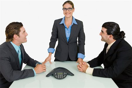 simsearch:625-02931286,k - Two businessmen and a businesswoman smiling in a board room Stock Photo - Premium Royalty-Free, Code: 625-01748420