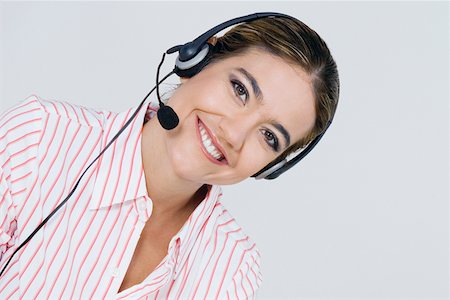 simsearch:625-01748850,k - Portrait of a businesswoman wearing a headset and smiling Foto de stock - Sin royalties Premium, Código: 625-01748534