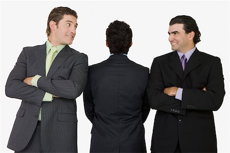 simsearch:625-00838657,k - Rear view of a businessman standing with two businessmen with their arms crossed Stock Photo - Premium Royalty-Free, Code: 625-01748536