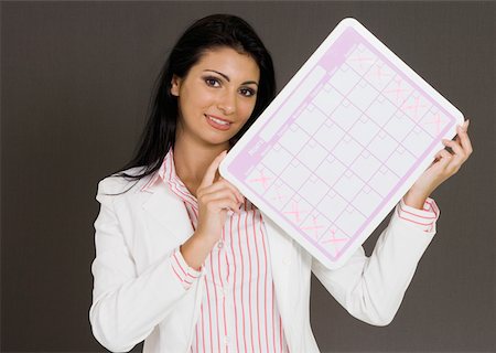 simsearch:625-01748576,k - Close-up of a businesswoman holding a calendar Foto de stock - Royalty Free Premium, Número: 625-01748560