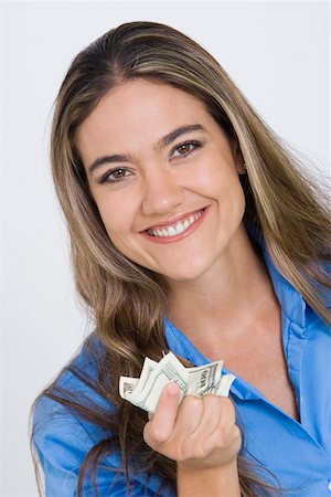 simsearch:6109-06007163,k - Close-up of a young woman holding US paper currency Fotografie stock - Premium Royalty-Free, Codice: 625-01748602