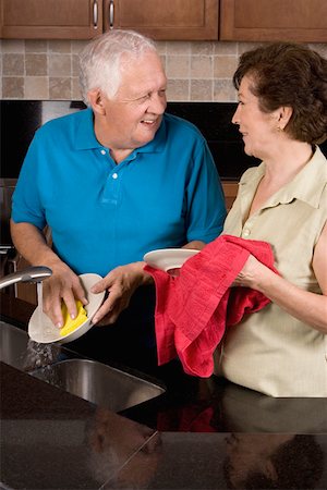 senior woman and profile and closeup and hispanic - Close-up of a senior couple cleaning plates in the kitchen Stock Photo - Premium Royalty-Free, Code: 625-01748623