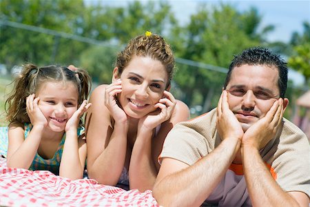 simsearch:633-05401448,k - Portrait of a mid adult couple with their daughter lying on a picnic blanket Stock Photo - Premium Royalty-Free, Code: 625-01748729