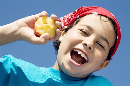 simsearch:625-01748263,k - Close-up of a boy holding an apple and smiling Stock Photo - Premium Royalty-Free, Code: 625-01748735