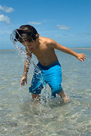 Boy playing on the beach Stock Photo - Premium Royalty-Free, Code: 625-01748893