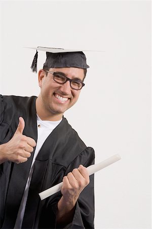 simsearch:625-01748942,k - Portrait of a mid adult man showing a thumbs up sign and holding a diploma Foto de stock - Sin royalties Premium, Código: 625-01748936