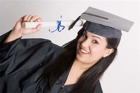 simsearch:625-01748850,k - Portrait of a young woman holding a diploma and smiling Foto de stock - Sin royalties Premium, Código: 625-01748938