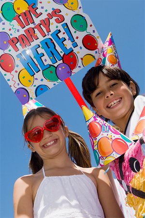 simsearch:625-01748263,k - Portrait of a girl with her brother wearing birthday hats and smiling Stock Photo - Premium Royalty-Free, Code: 625-01749039