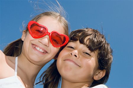 Portrait of a girl smiling with her brother Stock Photo - Premium Royalty-Free, Code: 625-01749045