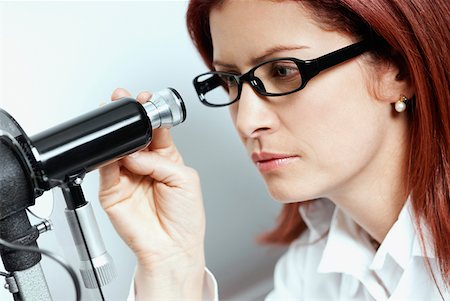 eye care medicine - Close-up of a female optometrist using a phoropter Stock Photo - Premium Royalty-Free, Code: 625-01749212