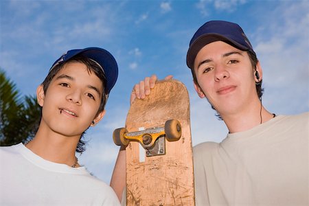 Portrait of two young men standing with a skateboard Stock Photo - Premium Royalty-Free, Code: 625-01749357