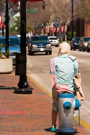 Rear view of a person sitting on a fire hydrant, Orlando, Florida, USA Fotografie stock - Premium Royalty-Free, Codice: 625-01749618