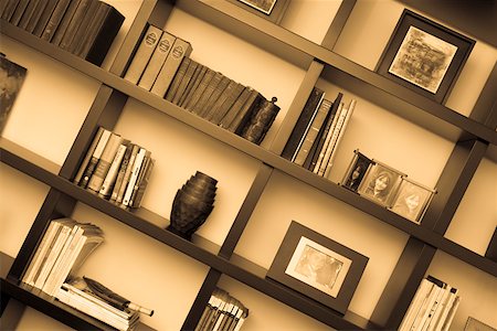 Books and picture frames in shelves Stock Photo - Premium Royalty-Free, Code: 625-01743725