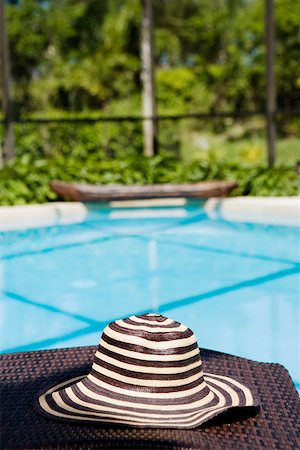 swimmingpool inside nobody - Close-up of a hat on a lounge chair at the poolside Stock Photo - Premium Royalty-Free, Code: 625-01743733